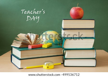 World Teacher's Day (still life with book pile, apple, globe and desk on artistic background)