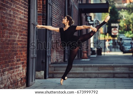 Elegant ballet dancer woman dancing ballet in the city