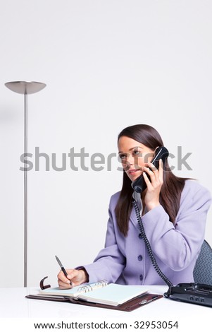 for english operator telephone conversation telephone whilst desk the at talking Businesswoman on office sat her