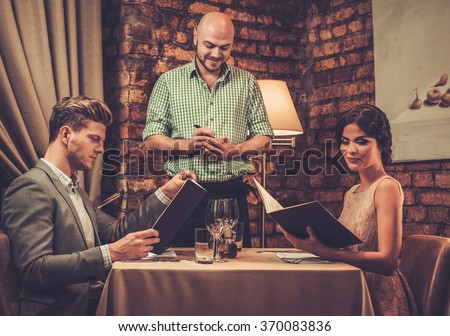 https://thumb9.shutterstock.com/display_pic_with_logo/78238/370083836/stock-photo-waiter-taking-order-from-stylish-wealthy-couple-in-restaurant-370083836.jpg