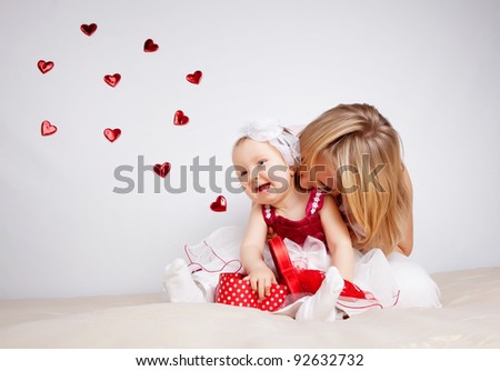 Child with hearts flying out of box isolated on white