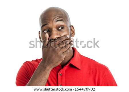 Handsome late 20s black man covering mouth with hand isolated on white