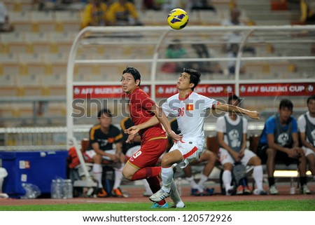 BANGKOK THAILAND-NOVEMBER 30:Nguyen Gia Tu of Vietnam ( white) in action during the AFF Suzuki Cup between Vietnam and Thailand at Rajamangala stadium on Nov30, 2012 in Bangkok,Thailand.