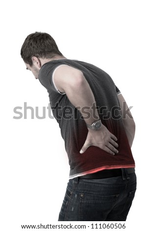 Young man holding his back in pain
