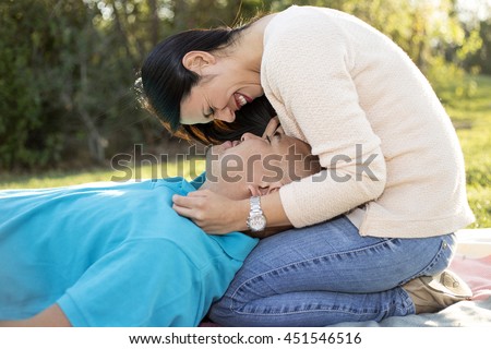https://thumb9.shutterstock.com/display_pic_with_logo/797713/451546516/stock-photo-young-hispanic-couple-on-a-romantic-outdoor-picnic-date-in-a-park-the-man-is-laying-while-the-451546516.jpg