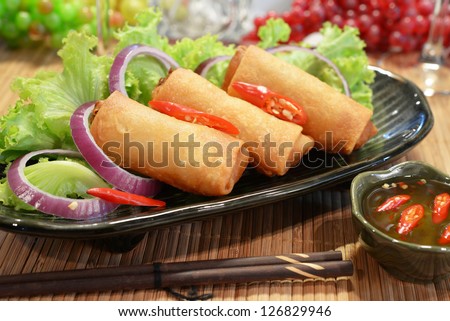 three piece of spring rolls on dish