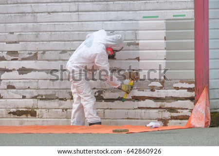 A person wears protective clothing to protect against toxic chemicals/Protective Clothing for Chemical Application/Protective clothing and face mask is worn to protect against toxic chemicals.