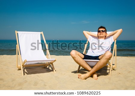 stock-photo-young-man-relaxing-on-beach-1089620225.jpg