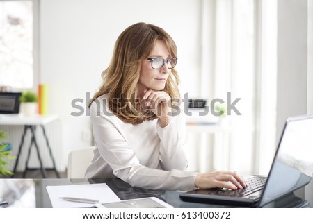 Shot of an attractive mature businesswoman working on laptop in her workstation.