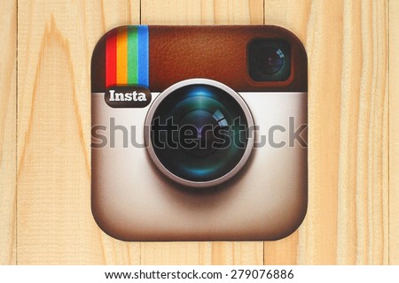 KIEV, UKRAINE - APRIL 30, 2015:Instagram logotype camera printed on paper and placed on wooden background. Instagram is an online mobile photo-sharing, video-sharing service.