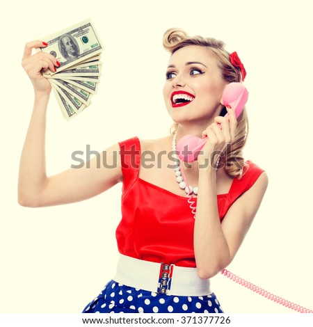 https://thumb9.shutterstock.com/display_pic_with_logo/82755/371377726/stock-photo-portrait-of-beautiful-young-happy-woman-with-money-talking-on-phone-dressed-in-pin-up-style-dress-371377726.jpg