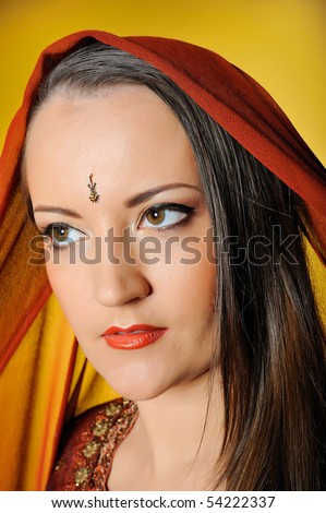 https://thumb9.shutterstock.com/display_pic_with_logo/83367/83367,1275292055,6/stock-photo-young-beautiful-woman-in-indian-traditional-style-bindi-and-sari-dress-yellow-background-54222337.jpg