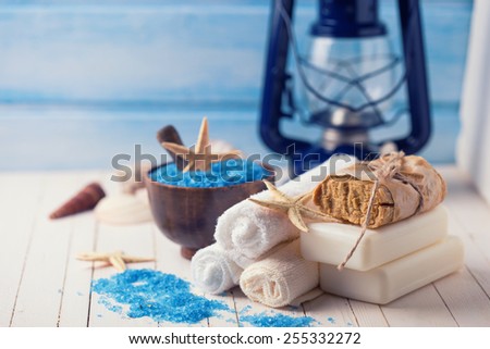 Spa setting with soap, towels, sea salt on painted wooden boards. Selective focus.Toned image.