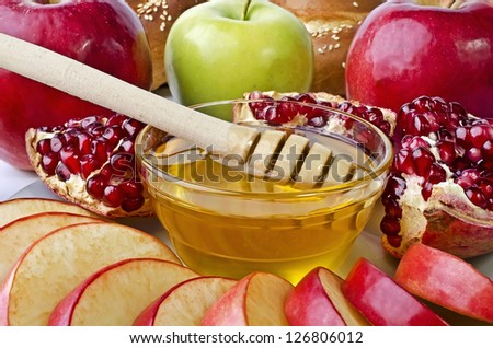 Still life closeup - challah, apples, pomegranate and bowl of honey closeup. Illustration of Rosh Hashanah (jewish new year) or Savior of the Apple Feast Day