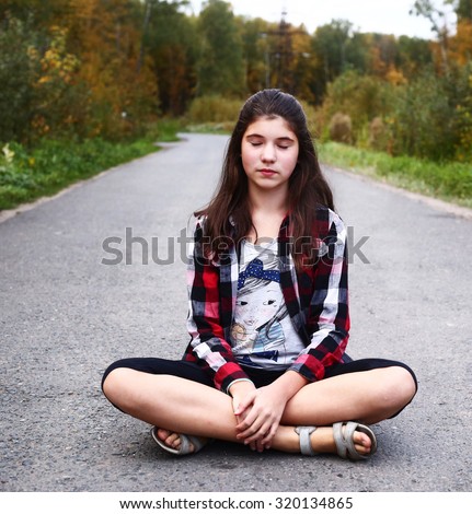 https://thumb9.shutterstock.com/display_pic_with_logo/84772/320134865/stock-photo-beautiful-teen-girl-sit-on-the-country-empty-road-320134865.jpg