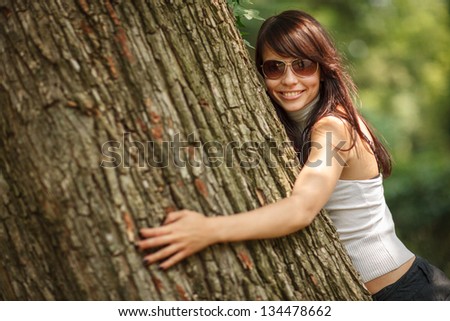 Happy Beautiful Girl Hugging Big Tree In Park Smiling Shallow Dof