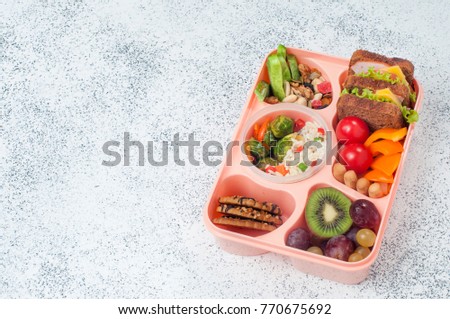 Healthy Food Concept Open Lunch Box With Sandwiches Vegetable Salad Fresh Grape And Healthy Food Concept Open Lunch Box With Sandwiches Vegetable Salad Fresh Grape And