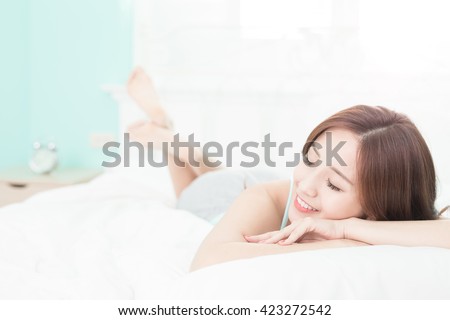 Health woman Smile feel carefree and she lying on the bed in the morning , asian girl