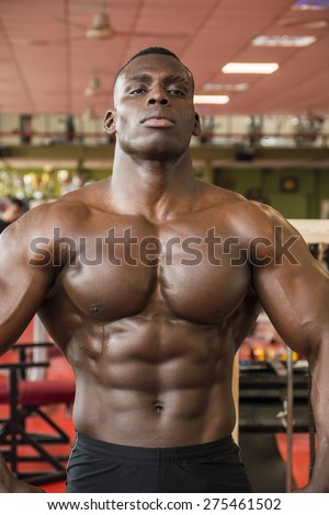 stock-photo-attractive-hunky-black-male-bodybuilder-doing-bodybuilding-pose-in-gym-275461502.jpg