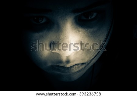 Out from the dark,Portrait of scary girl staring at cameras,Ghost girl hiding from the dark,Horror background for halloween Out from the dark,Portrait of scary girl staring at cameras,Ghost girl hiding from the dark,Horror background for halloween