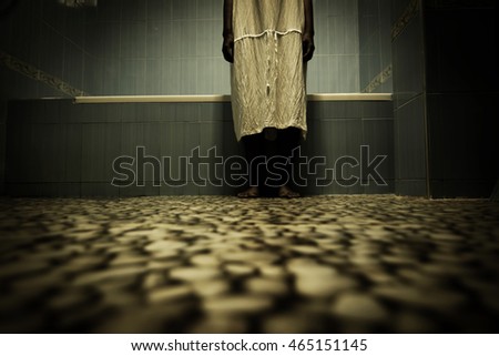 Scary person in white dress standing close to bathtub,Scary background for book cover Scary person in white dress standing close to bathtub,Scary background for book cover