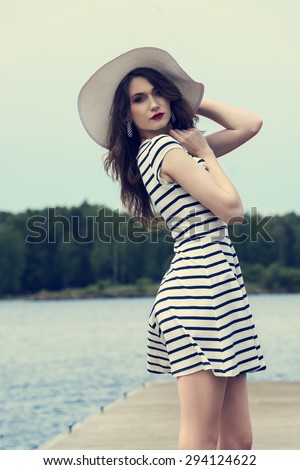 https://thumb9.shutterstock.com/display_pic_with_logo/89419/294124622/stock-photo-beautiful-woman-in-elegant-dress-and-white-hat-enjoying-a-sunny-day-posing-near-a-lake-on-the-294124622.jpg