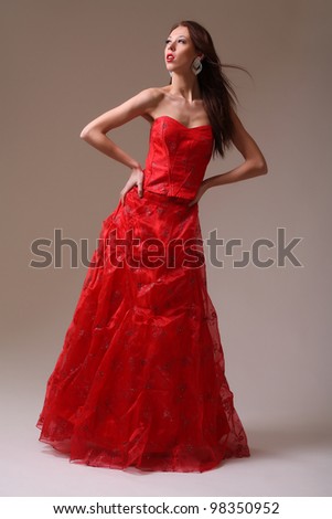 Young fashion model in red dress - stock photo
