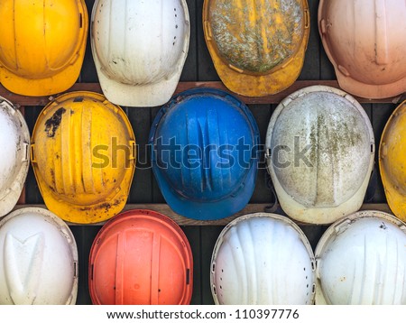 Old and worn colorful construction helmets