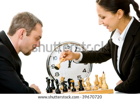 Image of businessman and businesswoman playing in chess with clock on background