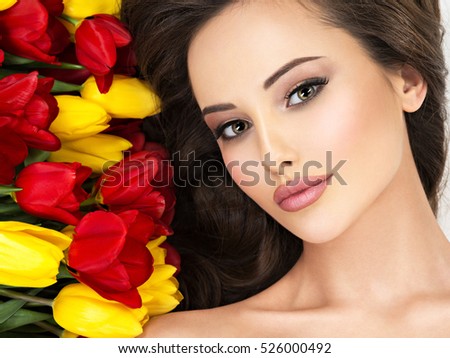 https://thumb9.shutterstock.com/display_pic_with_logo/93178/526000492/stock-photo-closeup-amazing-beauty-face-of-the-young-woman-with-flowers-attractive-model-with-red-and-yellow-526000492.jpg