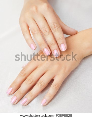 Massage of woman's hand on the white tablecloth
