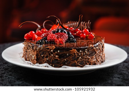 Luscious chocolate cake with fresh berries - stock photo