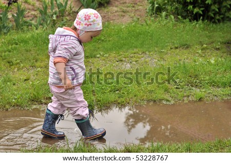 girl playing in the puddle
