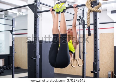 stock-photo-fit-girl-training-abs-by-raising-legs-on-a-horisontal-bar-fitness-woman-workout-doing-exercises-at-370175642.jpg