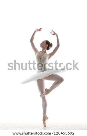silhouette of ballerina in classical tutu in the white studio
