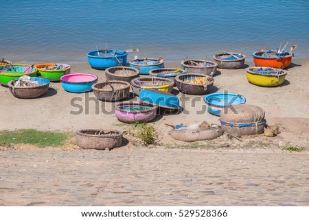 Colorful traditional boats in fishing village, Mui Ne, Binh Thuan Province, Vietnam, Southeast Asia. Round basket boats, Thung Chai. Sea shore. Popular asian landmark, famous destination of Vietnam