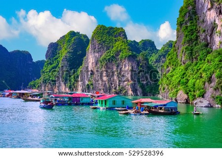Floating fishing village rock island in Halong Bay Vietnam, Southeast Asia. UNESCO World Heritage Site. Junk boat cruise to Ha Long Bay. Landscape. Popular asian landmark famous destination of Vietnam