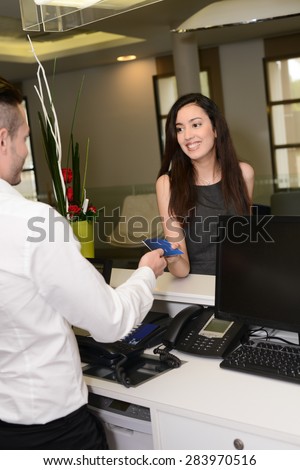 https://thumb9.shutterstock.com/display_pic_with_logo/973984/283970516/stock-photo-handsome-young-man-receptionist-handing-over-room-keys-to-a-beautiful-woman-in-hotel-front-desk-283970516.jpg
