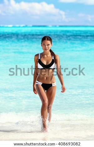 https://thumb9.shutterstock.com/display_pic_with_logo/97565/408693082/stock-photo-sexy-bikini-woman-on-beach-coming-out-of-water-walking-relaxing-on-tropical-getaway-paradise-young-408693082.jpg