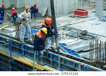 stock photo turkish construction workers poured concrete solution of the concrete pump into the formwork wall 379111126