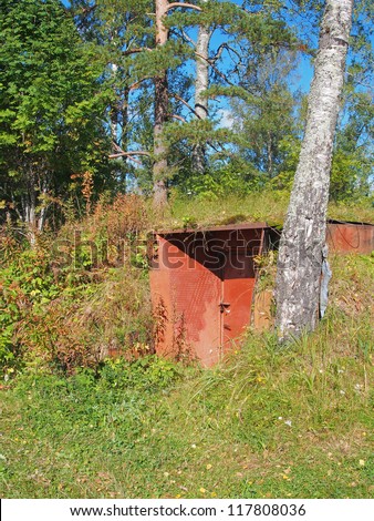Entrance in an air-raid shelter underground in the forest. Russia. Karelia.
