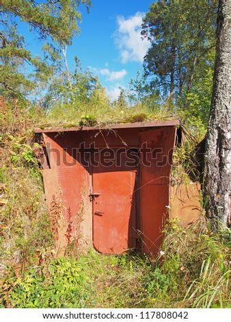Entrance in an air-raid shelter underground in the forest. Russia. Karelia.