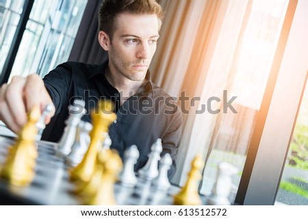 business competition concept with man playing chess game board
