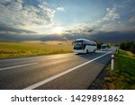 Two White Buses Traveling On...