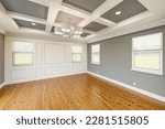 Small photo of Beautiful Gray Custom Master Bedroom Complete with Entire Wainscoting Wall, Fresh Paint, Crown and Base Molding, Hard Wood Floors and Coffered Ceiling