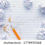 Small photo of School supplies of blank lined notebook paper with eraser marks and erased pencil writing, surrounded by balled up paper and a sharp pencil. Studying or writing mistakes concept.