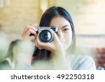 Asian beautuful women use camera totke photo forground blurred, Close up
