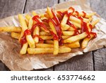 French fries with ketchup served on parchment paper