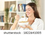 Happy Woman Eating Cereals For...