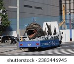 Small photo of TOKYO, JAPAN - November 3, 2023: A model of Godzilla on a truck in Tokyo's Kyobashi area. It's promoting the new Godzilla movie, 'Godzilla Minus One' (gojira-1.0).